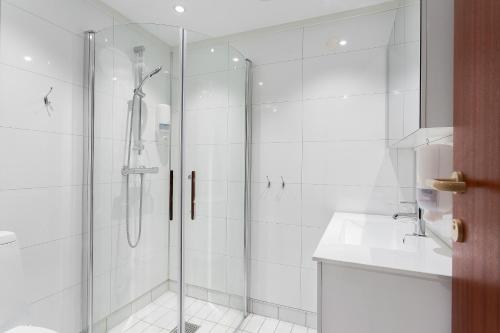 a bathroom with a shower and a sink at Aiden by Best Western Haugesund Airport in Avaldsnes