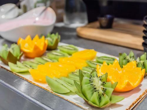 a plate of sliced fruit on a counter at Hotel ibis Bragança in Bragança