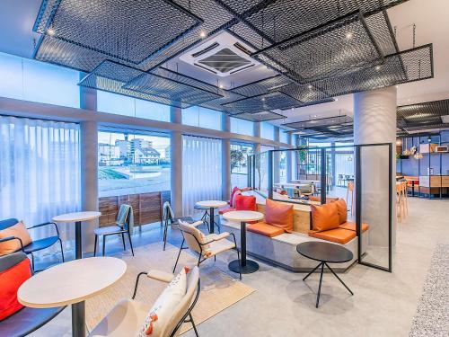 an office with tables and chairs and windows at Hotel ibis Bragança in Bragança