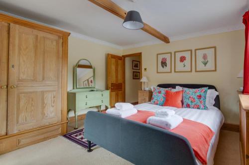 a bedroom with a bed with towels on it at St Lawrence House in Harpley