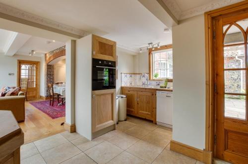a kitchen with a sink and a stove top oven at St Lawrence House in Harpley