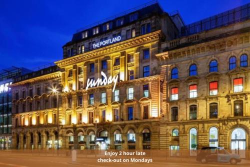 a building with a sign on the front of it at Manchester Portland By Sunday in Manchester