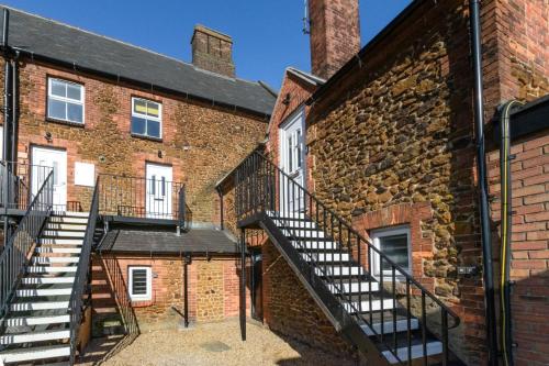 a brick building with stairs in front of it at Daisy’s - Ellinbrook Apartments in Hunstanton