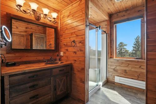 a bathroom with a shower and a sink and a mirror at Ponca Lode Retreat in Keystone