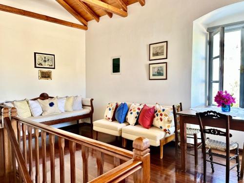 a living room with couches and a table at Kaminēa in Hydra