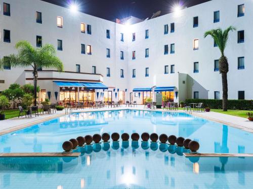 a large pool in front of a hotel at Ibis Meknès in Meknès