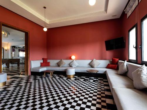 a living room with a couch and a checkered floor at Ibis Meknès in Meknès