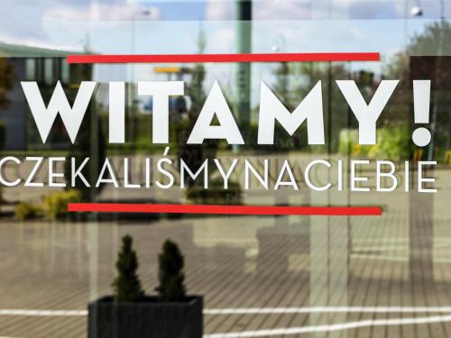 a window with the wimmy collective logo on it at Ibis Częstochowa in Częstochowa