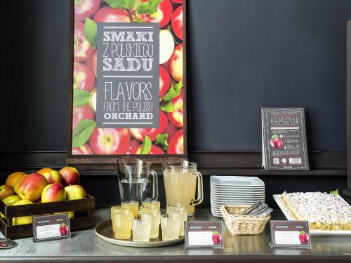 a buffet with apples and drinks on a table at Ibis Częstochowa in Częstochowa