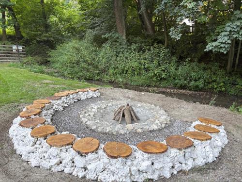 a fire pit made out of logs and rocks at Korzkiewka 