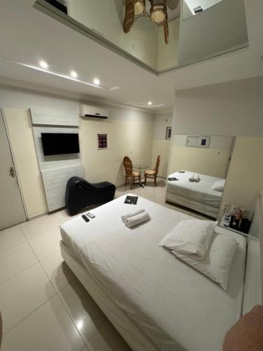 a bedroom with a large white bed in a room at D'lazer Motel in Caruaru