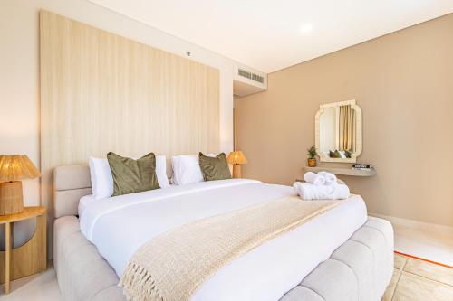 a bedroom with a large white bed in a room at Groups and Families Paradise - 5 min from ADGM, Galleria, Cleveland, Beach, etc - Designer's Choice - New Building - Heart of Al Reem in Abu Dhabi