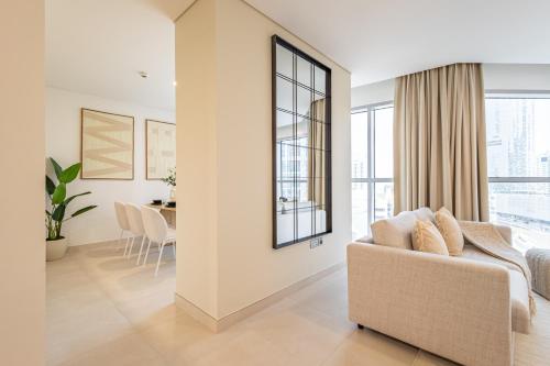 a living room with a couch and a table at Groups and Families Paradise - 5 min from ADGM, Galleria, Cleveland, Beach, etc - Designer's Choice - New Building - Heart of Al Reem in Abu Dhabi