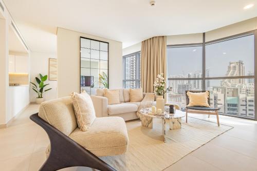 a living room with a couch and a table at Groups and Families Paradise - 5 min from ADGM, Galleria, Cleveland, Beach, etc - Designer's Choice - New Building - Heart of Al Reem in Abu Dhabi