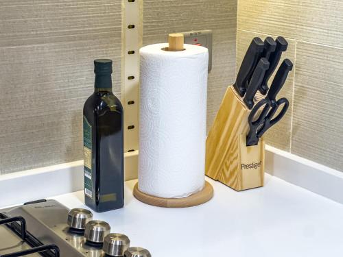 a roll of paper towels next to a bottle of wine at Groups and Families Paradise - 5 min from ADGM, Galleria, Cleveland, Beach, etc - Designer's Choice - New Building - Heart of Al Reem in Abu Dhabi