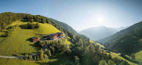 an aerial view of a house on a hill at Bruneggerhof Weissenbach in Rio Bianco