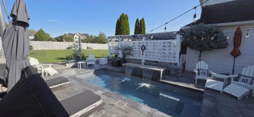 a backyard with a swimming pool and a house at Staycation Oasis! a unique Experience! Heated pool open until October 31st in Easton