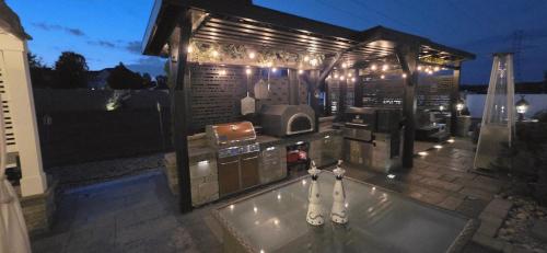 a house with a swimming pool with lights on it at Staycation Oasis! a unique Experience! Heated pool open until October 31st in Easton
