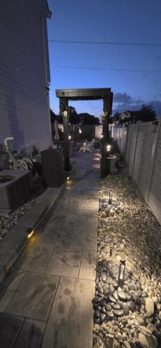 a patio with a stone walkway with a fence at Staycation Oasis! a unique Experience! Heated pool open until October 31st in Easton