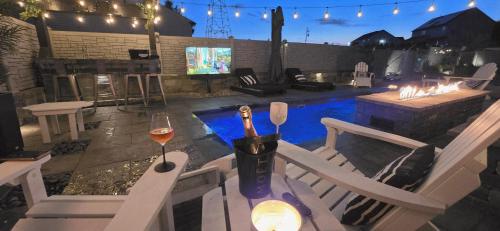 a patio with a table with a glass of wine at Staycation Oasis! a unique Experience! Heated pool open until October 31st in Easton