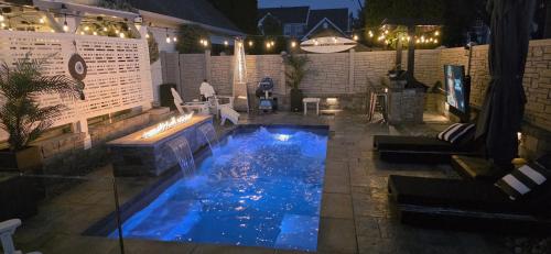 a swimming pool in a backyard at night at Staycation Oasis! a unique Experience! Heated pool open until October 31st in Easton