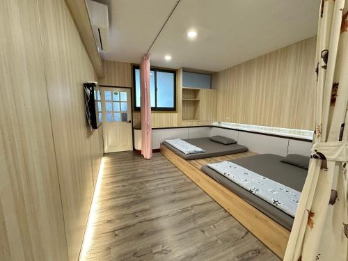 a room with two beds in the middle of it at HJ Station in Lu-feng