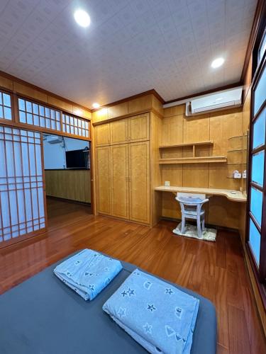 a room with two blue mattresses on a wooden floor at HJ Station in Lu-feng