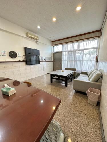 a living room with a couch and a table at HJ Station in Lu-feng