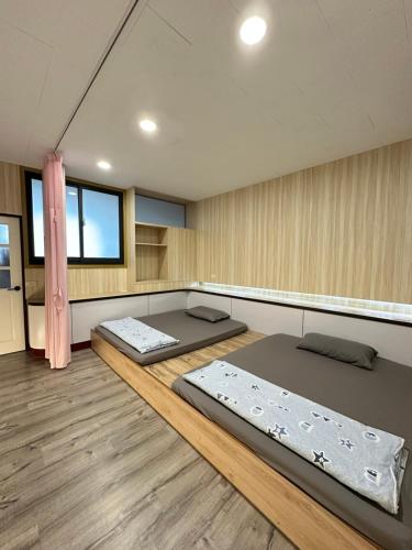 a room with two beds in the middle of it at HJ Station in Lu-feng
