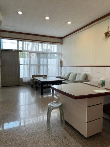 a large living room with a couch and a table at HJ Station in Lu-feng
