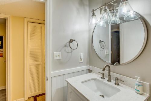 a bathroom with a sink and a mirror at Direct Beach Access! Walkable Condo on Ocean Blvd in Myrtle Beach