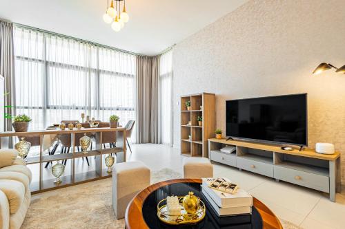 a living room with a large flat screen tv at Amazing Rooftop Pool - Full Canal Views - 1 BDR - 5 min walk from Space42 Arena - Heart of Raha Beach in Abu Dhabi