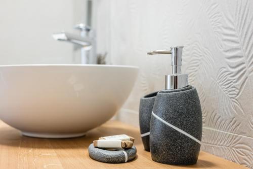 a bathroom with a black soap dispenser and a sink at Villa Sofija in Kojsko