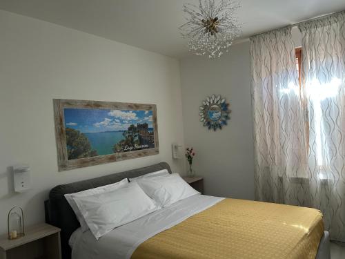 a bedroom with a bed and a chandelier at Dolce Dormire in Castiglione del Lago