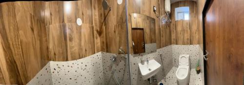 a bathroom with a sink and a toilet and a mirror at Luxe Villa in Sanikpuri, Hyderabad in Secunderabad