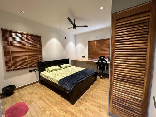 a bedroom with a bed and a ceiling fan at Luxe Villa in Sanikpuri, Hyderabad in Secunderabad