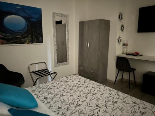 a bedroom with a bed and a cabinet and a desk at Dolce Dormire in Castiglione del Lago