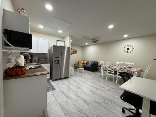 a kitchen and living room with a refrigerator and a table at Sunshine Nest in Lehigh Acres
