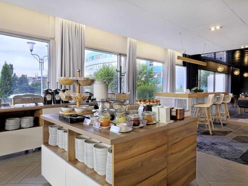 a kitchen with a counter with food on it at Novotel Katowice Centrum in Katowice