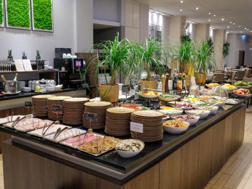 a buffet line with many different types of food at Mercure Warszawa Grand in Warsaw