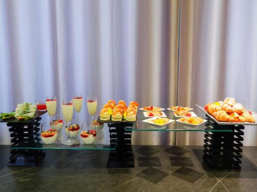 a buffet of food and drinks on a table at Mercure Warszawa Grand in Warsaw