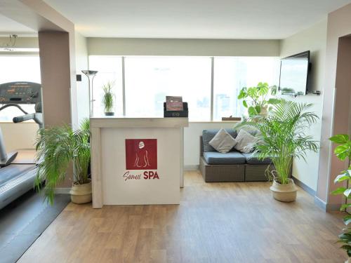 an office with a couch and a table with a sign at Novotel Warszawa Centrum in Warsaw
