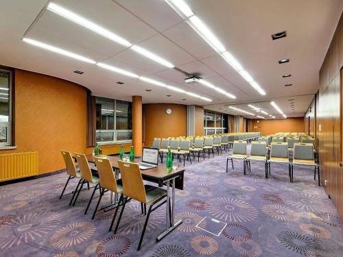 a conference room with a long table and chairs at Mercure Gdańsk Stare Miasto in Gdańsk