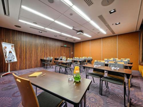 a dining room with tables and chairs and wooden walls at Mercure Gdańsk Stare Miasto in Gdańsk