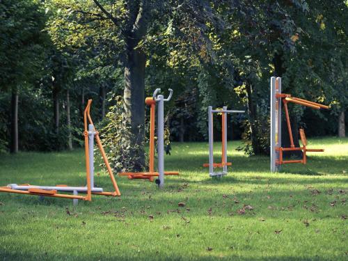 a group of playground equipment in the grass at Mercure Gdańsk Posejdon in Gdańsk