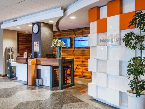 a lobby of a mcdonalds restaurant with a check in counter at Mercure Czestochowa Centrum in Częstochowa