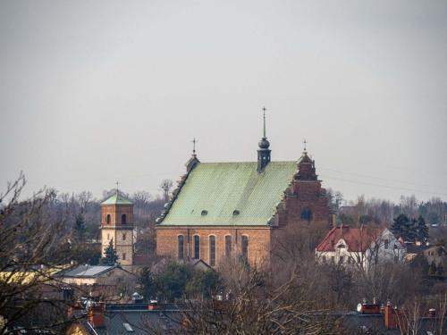 a large church with a green roof and a tower at Mercure Czestochowa Centrum in Częstochowa