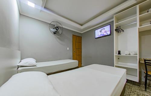 a room with two beds and a tv in it at Hotel Monte Palma - São Paulo Próximo a Arena Neo Química in Sao Paulo