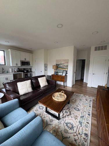 a living room with a couch and a table at Downtown Traverse City Capri Condo 316 in Traverse City