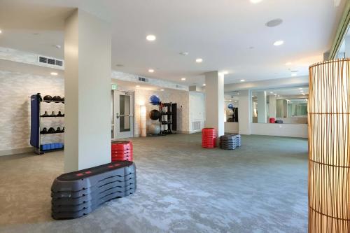 a large room with white walls and a gym with red drums at Premium Stay 10 Min From Disneyland With Pool & GYM in Tustin